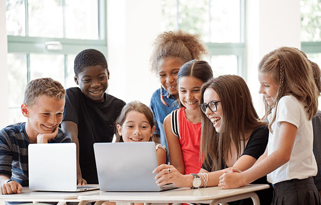 group of students conferencing with teacher